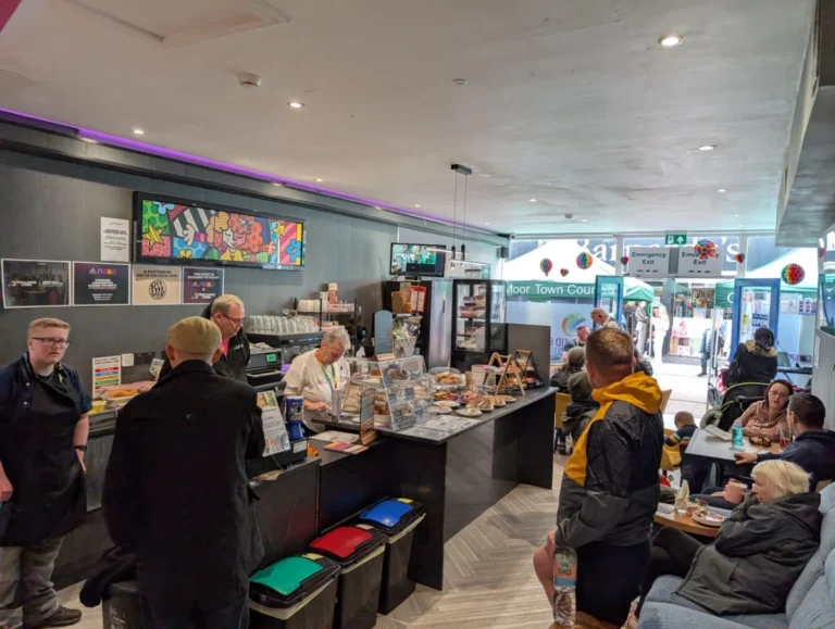 Customers at the cafe counter and seating inside the hub